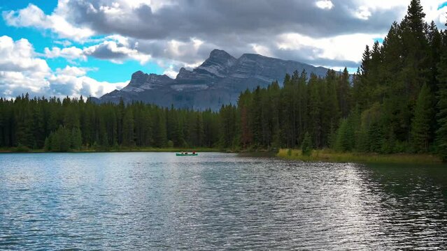 Canoe floating on Two Jack Lake with Mt. Rundle in Banff National Park, Canada