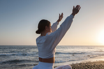 Healthy with Yoga Concept. Attractive young woman practice Warrior Pose (Virabhadrasana) in Yoga on sunset.