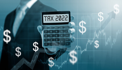 Tax 2022 on calculator. Business and tax concept. Businessman hold and show Calculator with word...