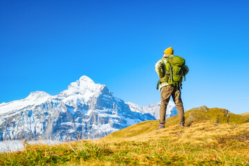 Tourist with a backpack in the mountains. Mountain hiking in the high mountains. Travel and...