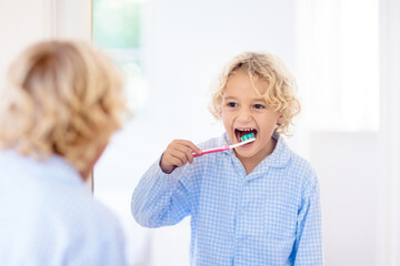 Child brushing teeth. Kids with toothpaste, brush.