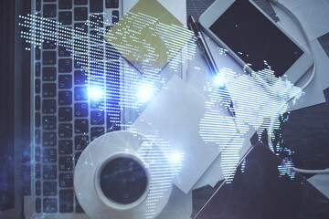 Social network hologram drawings over computer on the desktop background. Top view. Multi exposure....