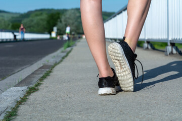 Running feet on the street closeup on the shoe. Women Fitness Jogging Training 