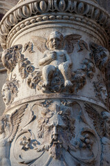 Fototapeta na wymiar Venezia. Altorilievo con putto su colonna sulla facciata della Scuola Grande di san Marco