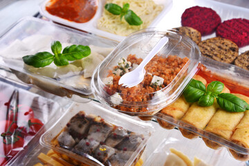 A variety of prepackaged food products in plastic boxes