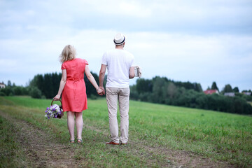 Fototapeta premium Pregnant girl with big belly and young man outdoor