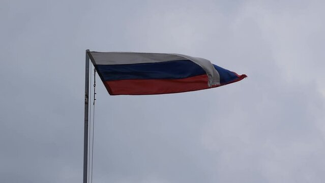 Serbian flag fluttering in wind against clouds, national symbol of serbs