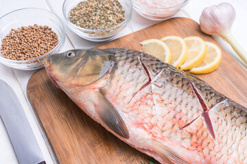 Incisions on carp fish before baking in the oven.