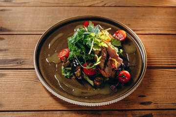 The waiter is served a plate of new dish of the restaurant.