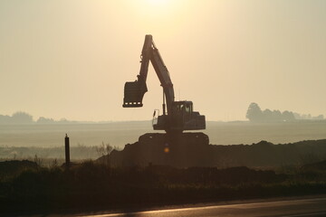 silhouette of an excavator.