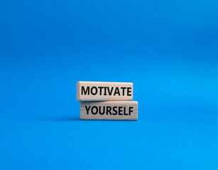 Motivation symbol. Concept words 'Motivate yourself' on wooden blocks. Beautiful blue background. Business and Motivate yourself concept. Copy space.