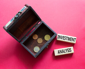 investment analysis symbol. Wooden blocks with words 'investment analysis' with wooden box. Beautiful red background. Business and 'investment analysis' concept. Copy space.