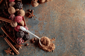 Chocolate truffles and spoon with cocoa powder.