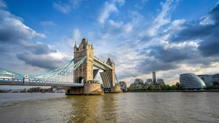 Fotobehang the open tower bridge of london against a dramatic sky © frank peters