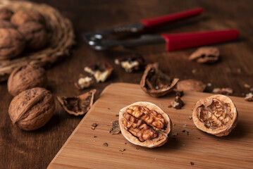 Walnuts on a stone plate next to a nutcracker. Close-up.