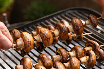 Portobello mushrooms on skewers grilled on barbecue, vegetarian vegan summer food