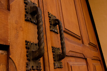 Wooden side door of a Catholic chapel.