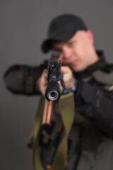 Ukrainian soldier with a machine gun aiming