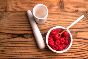 Obraz na płótnie Canvas Group of raspberries in white bowl. Healthy lifestyle. Fresh fruit. 