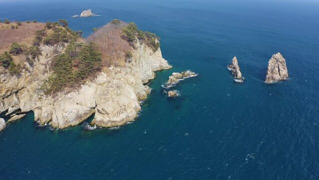 Kekura and rocky Cape Telyakovsky washed by the Sea of Japan on a sunny day. Far Eastern Marine Reserve. National park. Drone view. The concept of protecting protected areas
