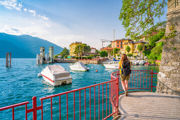 Beautiful blonde girl on The Walk of Lovers in Varenna, a pedestrian path over water, in the...