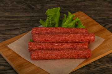 Raw beef sausages with spices