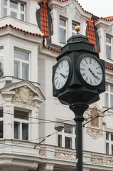 Fototapeta na wymiar Antique street clock in one of the old districts of Prague, Czech Republic.