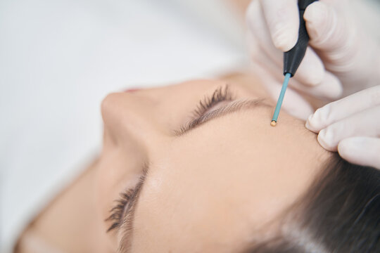 Woman receiving skincare treatment in cosmetology clinic