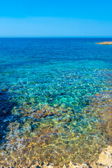 Fototapeta na wymiar Amazing crystal clear water in the beach of Porto Selvaggio Natural Reserve in Salento, Apulia Italy