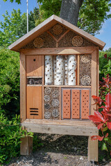 Bug hotel. Purpose built object for insects and bugs to shelter and lay eggs. wooden blocks and sticks made into a natural home for insects. Conservation image