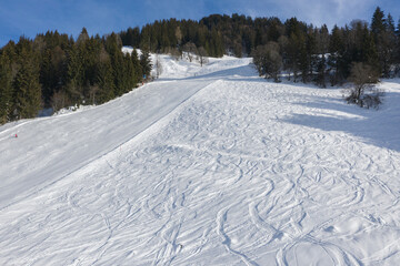 Fototapeta na wymiar Ski slope in winter sunny day.