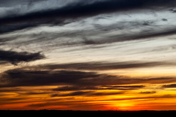Sunset with golden light, early evening, orange sunset on the field.