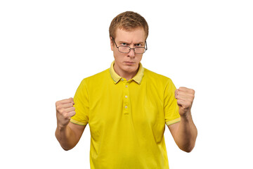 Unhappy geek guy in glasses and yellow T-shirt ready to fight with fists isolated white background