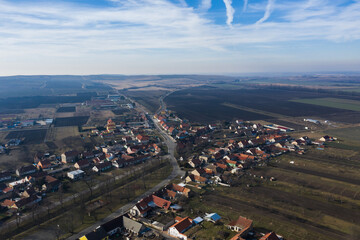 Aerial view of a rural landscape, farmland, village and hills.