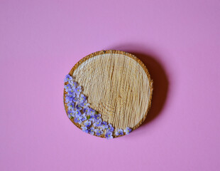 Round wooden saw, pedestal or podium for cosmetic or jewelry products. Presentation, advertising