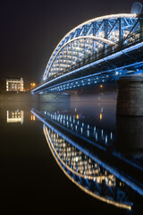 Pilsudski steel truss bridge over Vistula river in Krakow in the night