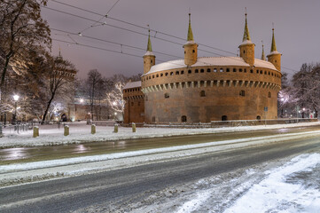 Medieval barbican (Barbakan) in the winter night, Krakow, Poland