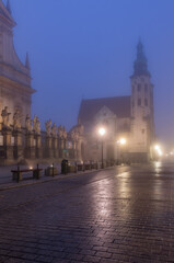 Fototapeta na wymiar Krakow old town, St Andrew church on Grodzka street in the foggy night