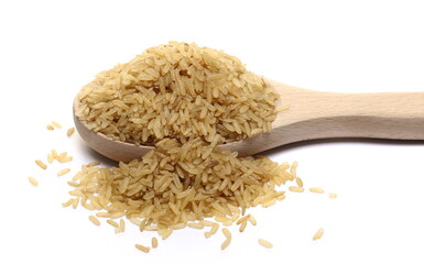 Integral uncooked rice pile in wooden spoon isolated on white  