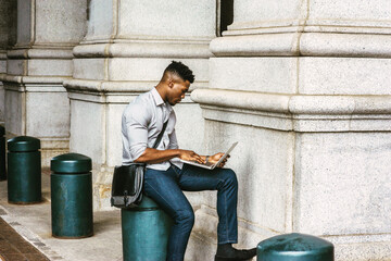 African American College Student studying in New York, wearing shirt, jeans, carrying shoulder...