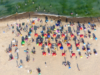 People bathing in the sun, swiming and playing games on the beach. Tourists on the sand beach of Zatoka, Ukraine