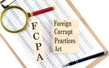 FCPA Foreign Corrupt Practices Act text on wooden block on chart background
