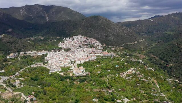 Aerial perspective of Ojen village, small town  located in the mountains, in the heart of the Costa del Sol, not far from Marbella. In background beautiful mountains of "Sierra Blanca" Drone Rotating