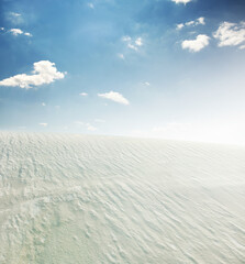 White sand dune in desert and blue sky on background