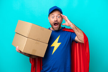 Super Hero delivery man isolated on blue background with surprise expression