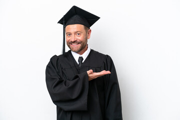 Middle age university graduate man isolated on white background presenting an idea while looking smiling towards