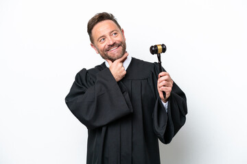 Naklejka premium Middle age judge man isolated on white background looking up while smiling