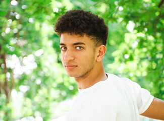 primo piano di bellissimo ragazzo con occhi azzurri al parco