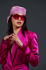 young woman in a pink mini dress fashion glasses pink headscarf luxury isolated background