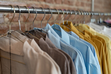 Organic eco clothes on hanger in store, soft focus. Home-made clothing from natural and processed...